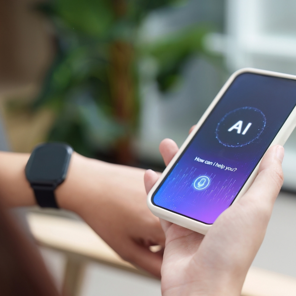 Hand holding a phone that shows an AI assistant