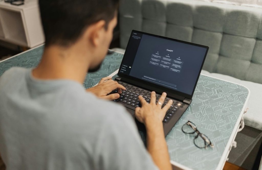 Person entering code on a laptop