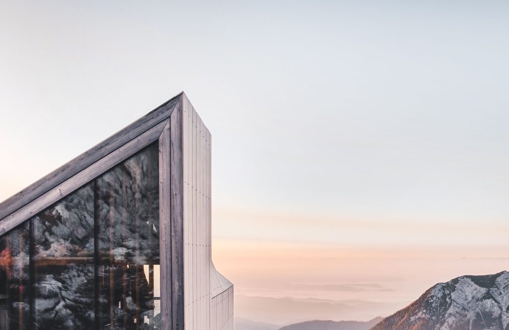 A wood-sided modern building at sunset